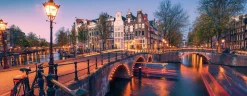 Ravensburger Panorama|Steden En Gebouwen<Avond in Amsterdam - panoramische legpuzzel van 1000 stukjes